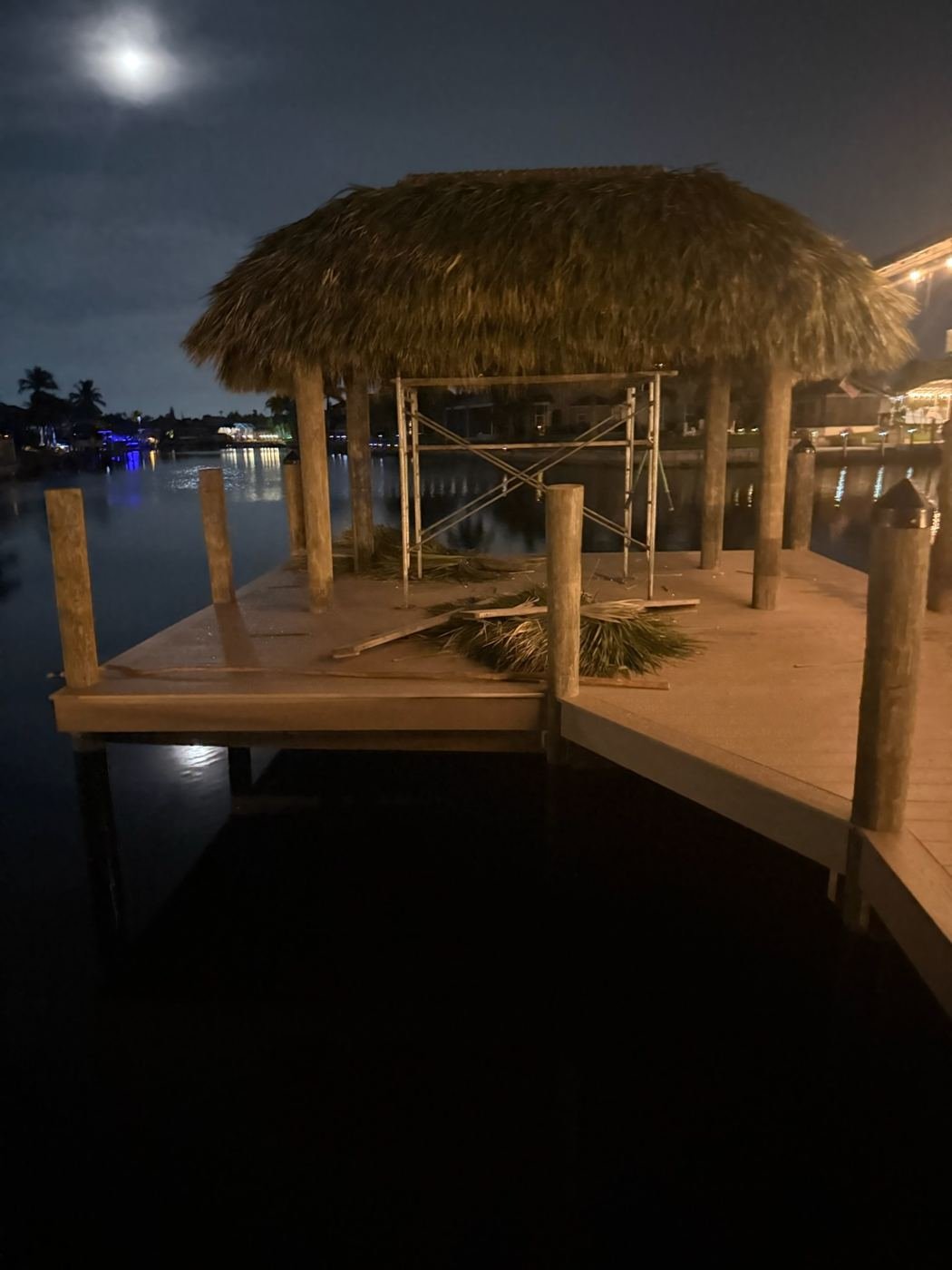 Hand-thatching a new tiki roof