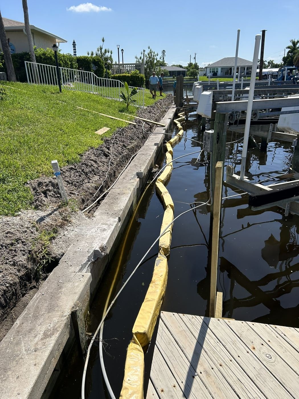 Cap replacement with turbidity barrier in place