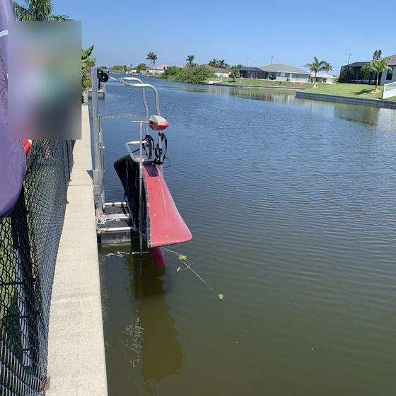 Canoe lift at the seawall with the canoe lowered to the water
