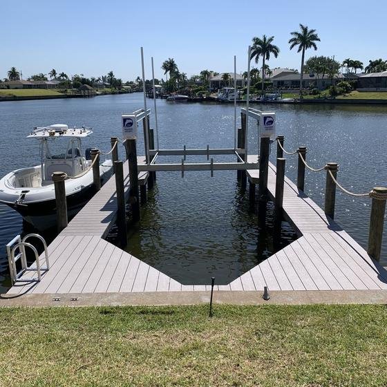Slate Gray vinyl dock with a U-shaped boat slip and lift