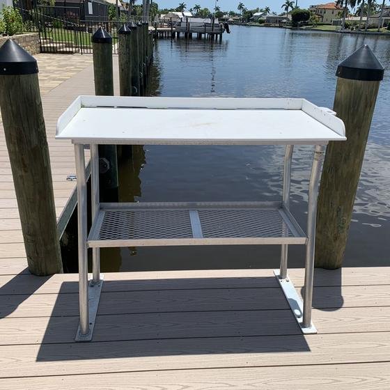 Fish cleaning table mounted between two pilings