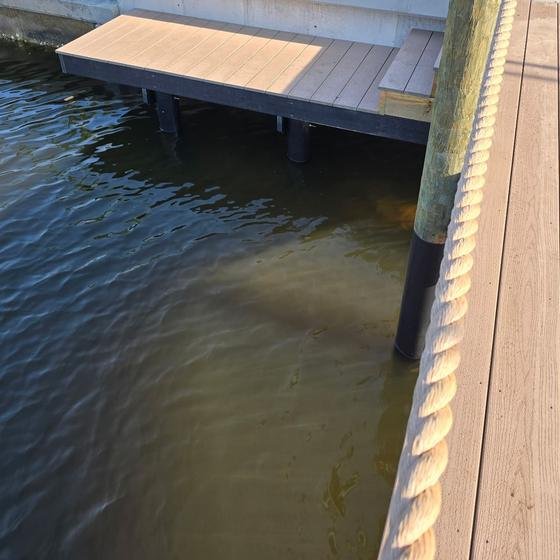 Low elevation kayak launch platform built close to the water beside a Brownstone vinyl dock