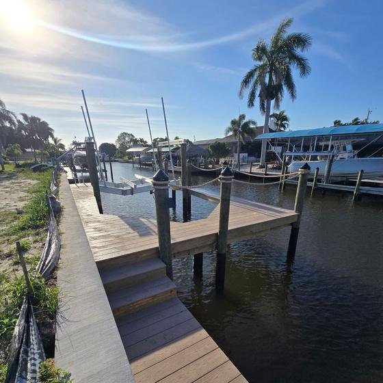 Brownstone vinyl dock with steps down to a lower landing near the water