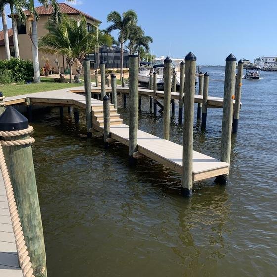 New vinyl dock on pilings with rope rail