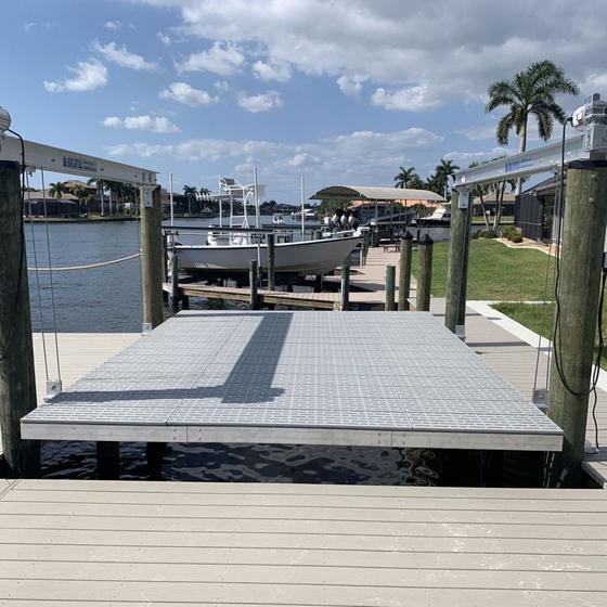 Platform lift with grated deck on a canal