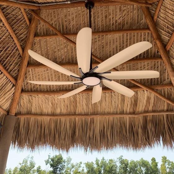Inside a tiki hut: log rafters, palm thatch and a ceiling fan